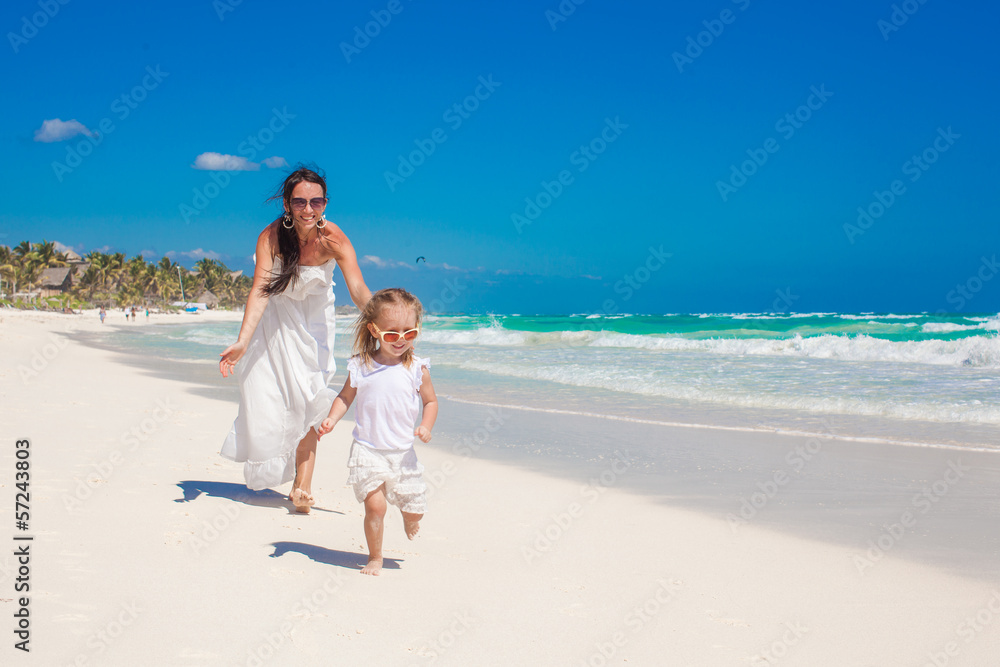 Cute funny daughter having fun with her nice young mother on the Cute funny daughter having fun with her nice young mother on the