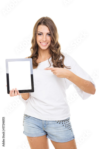 Attractive casual young woman showing tablet computer pointing