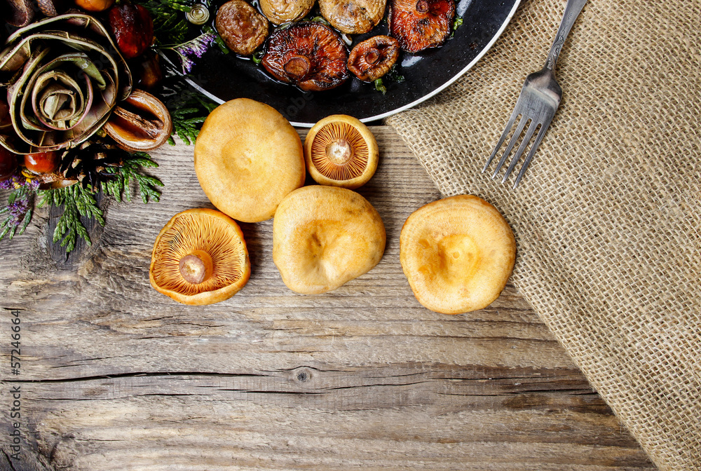 Saffron milk cap mushrooms on wooden table. Copy space