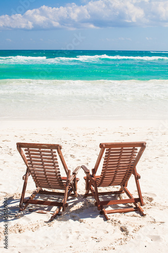 Beach wooden chairs for vacations and relax on tropical white © travnikovstudio