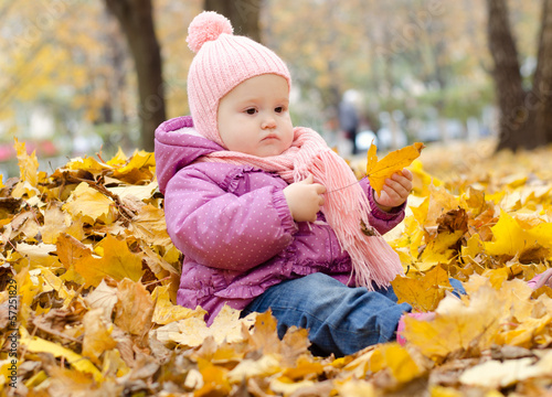 baby in a pile of leaves