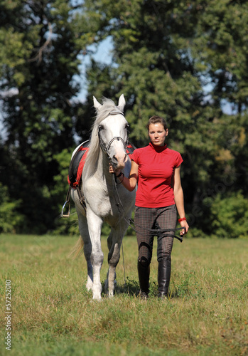 Girl getting horse ready to ride © horsemen