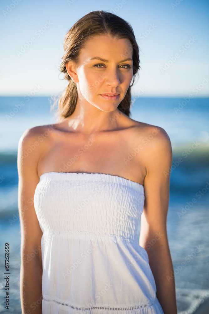 Serious brunette in white summer dress posing Serious brunette in white summer dress posing