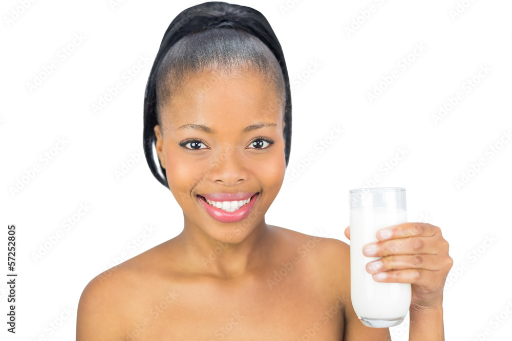 Happy woman holding glass of milk and looking at camera Happy woman holding glass of milk and looking at camera