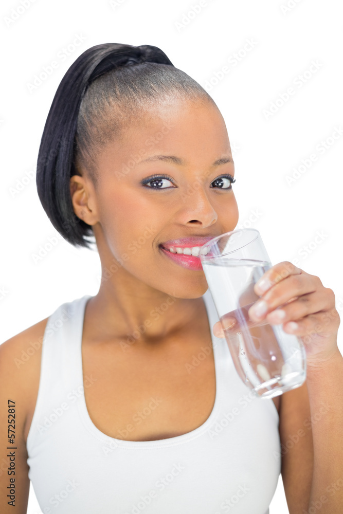 Smiling woman in sportswear drinking water Smiling woman in sportswear drinking water