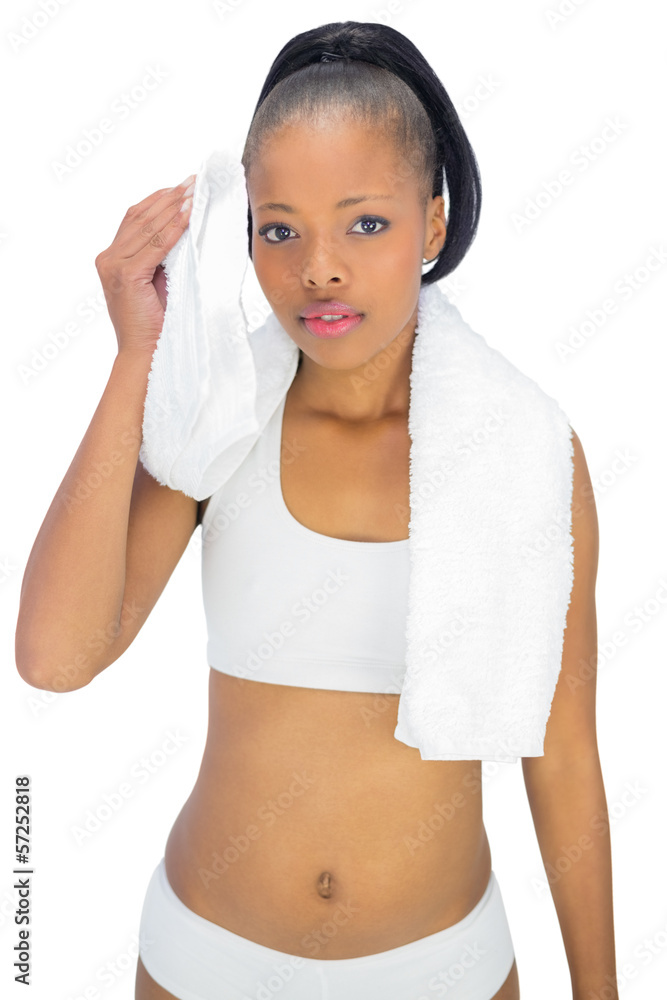 Sporty woman in sportswear using towel
