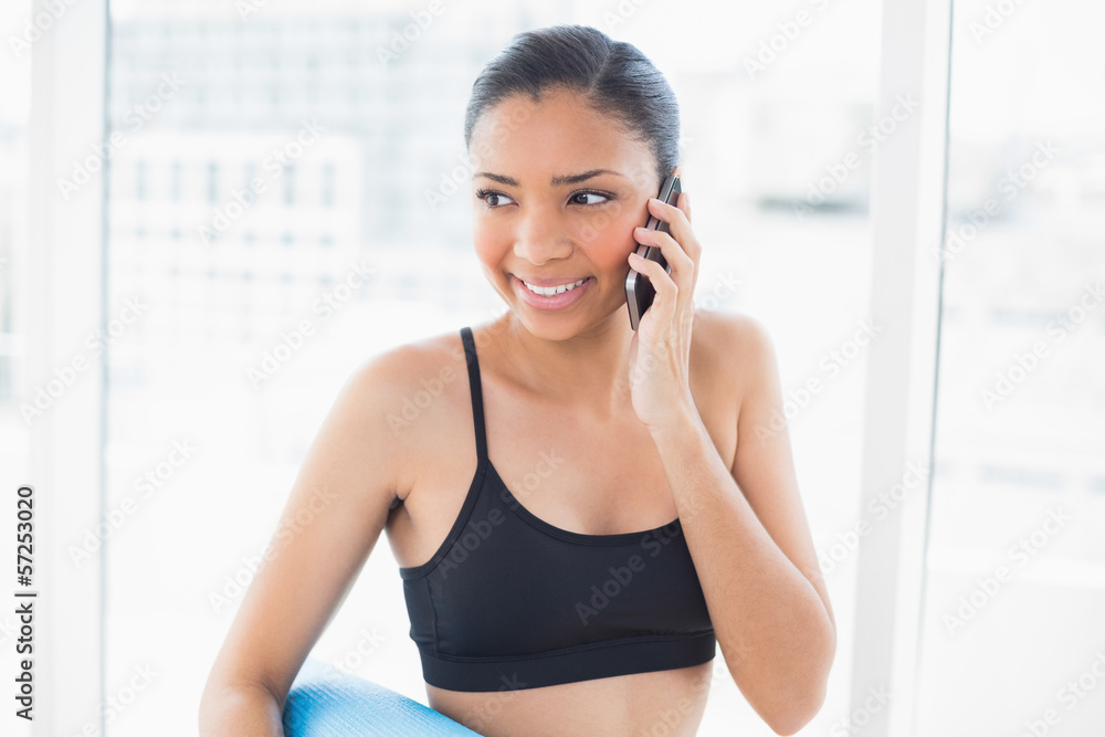 Pensive dark haired model in sportswear making a phone call Pensive dark haired model in sportswear making a phone call
