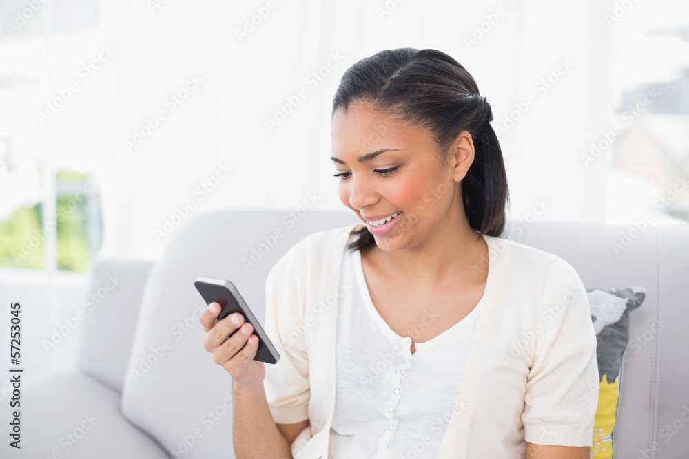 Happy young dark haired woman in white clothes looking at her mo Happy young dark haired woman in white clothes looking at her mo