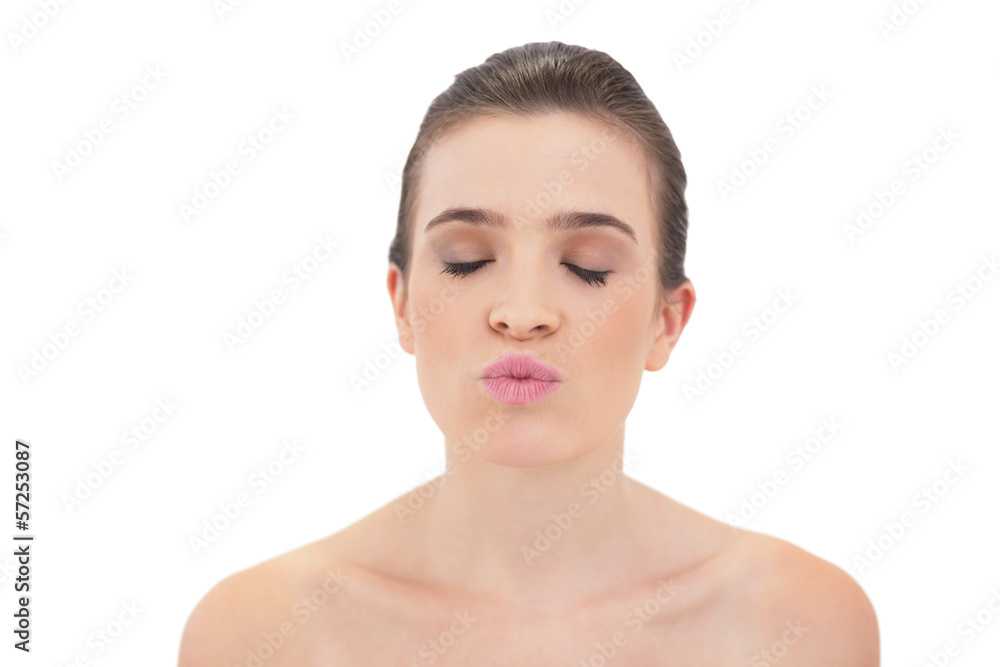 Peaceful natural brown haired model kissing the air and closing Peaceful natural brown haired model kissing the air and closing