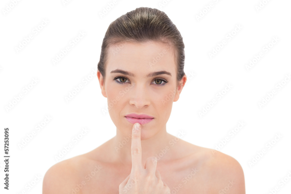 Calm natural brown haired model touching her lip Calm natural brown haired model touching her lip