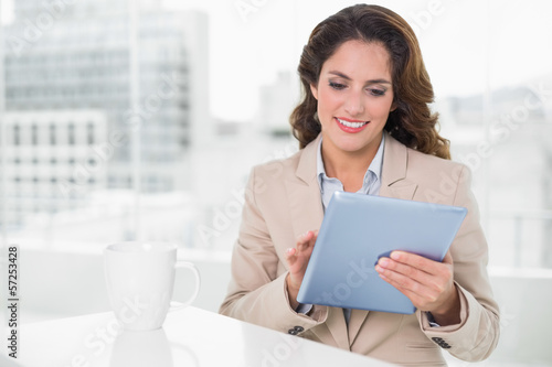 Beautiful smiling businesswoman using tablet