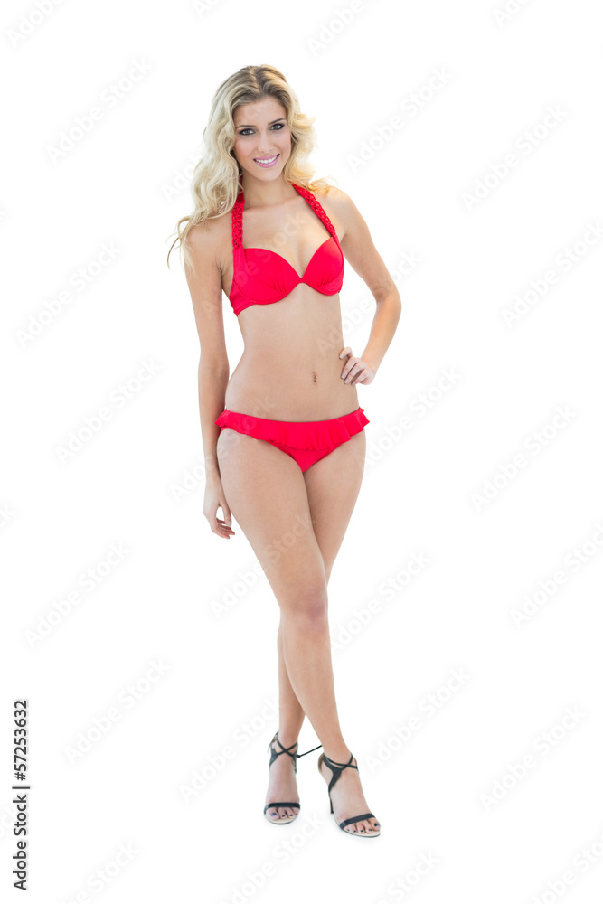 Beautiful smiling blonde model posing with hand on hips wearing Beautiful smiling blonde model posing with hand on hips wearing