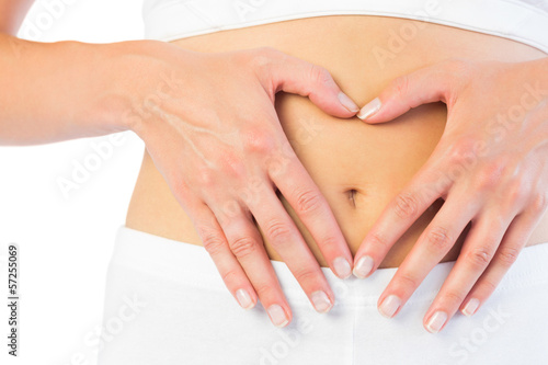 Close up picture of fit woman holding her belly