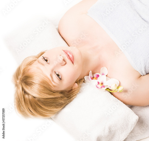 woman in spa salon lying on the massage desk