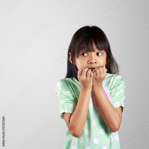 Scared little girl hiding face