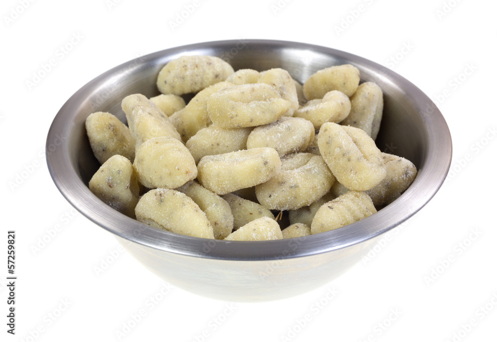 Uncooked potato gnocchi in a stainless steel bowl Uncooked potato gnocchi in a stainless steel bowl