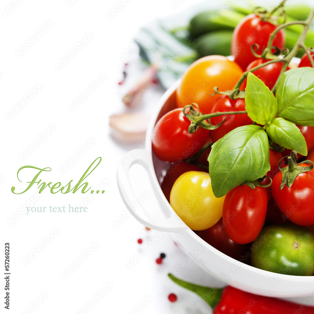 Assorted tomatoes and vegetables in colander Assorted tomatoes and vegetables in colander