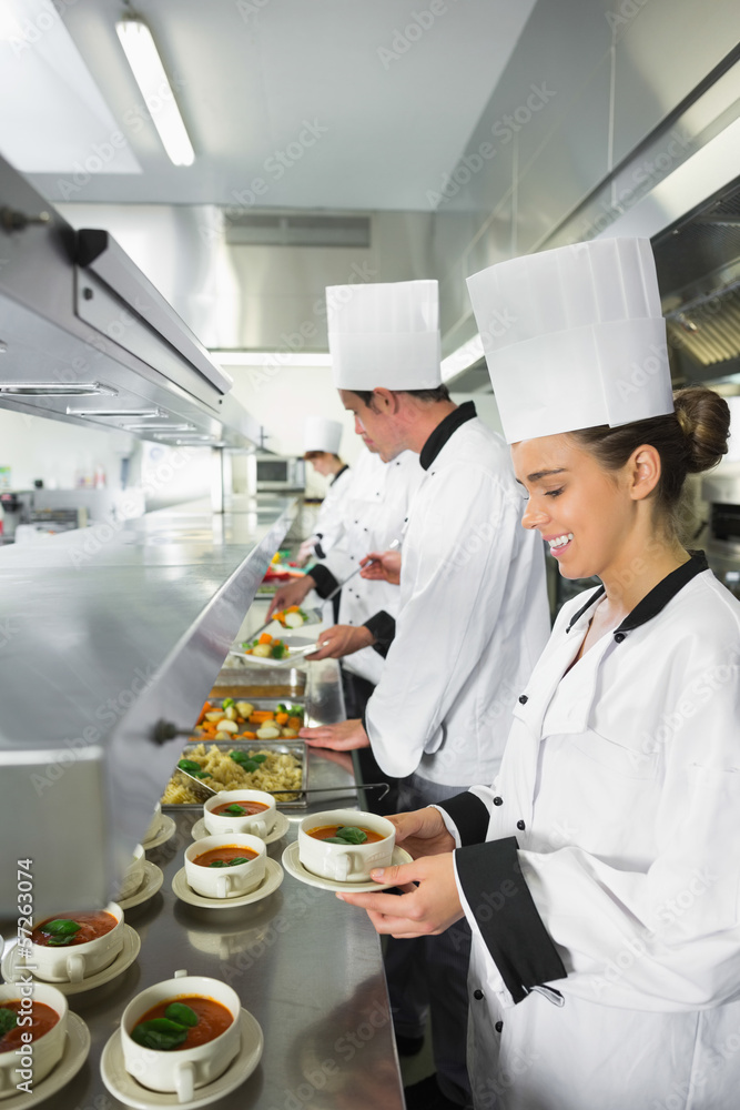 Four chefs working in a busy kitchen Four chefs working in a busy kitchen
