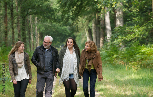 Mother and father walking through the woods with daughters