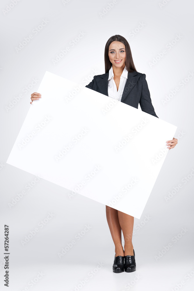 Young business woman holding big blank poster. Young business woman holding big blank poster.