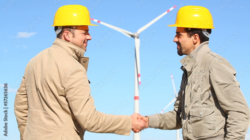 Engineers giving Handshake in Wind Turbine Power Station Engineers giving Handshake in Wind Turbine Power Station