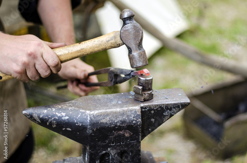 Blacksmith hammering an iron