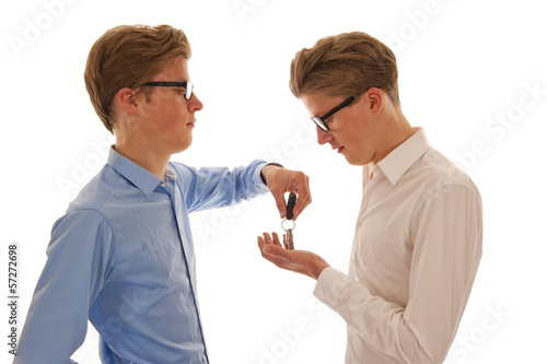 Two boys handing over keys