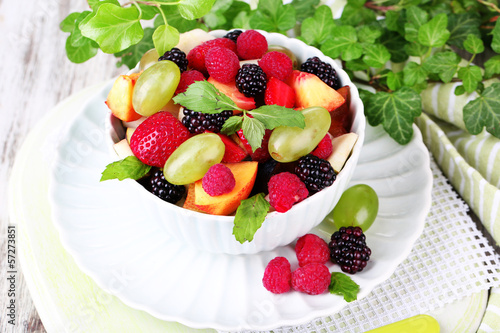 Fruit salad in bowl  on wooden table background