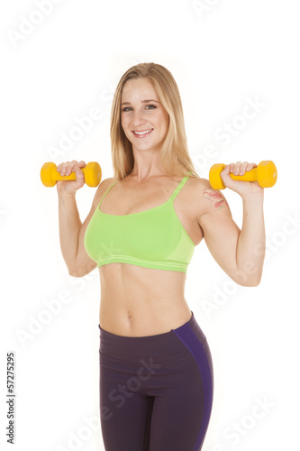fitness woman green bra weights by shoulders