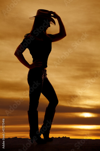 silhouette woman cowgirl side hand hat