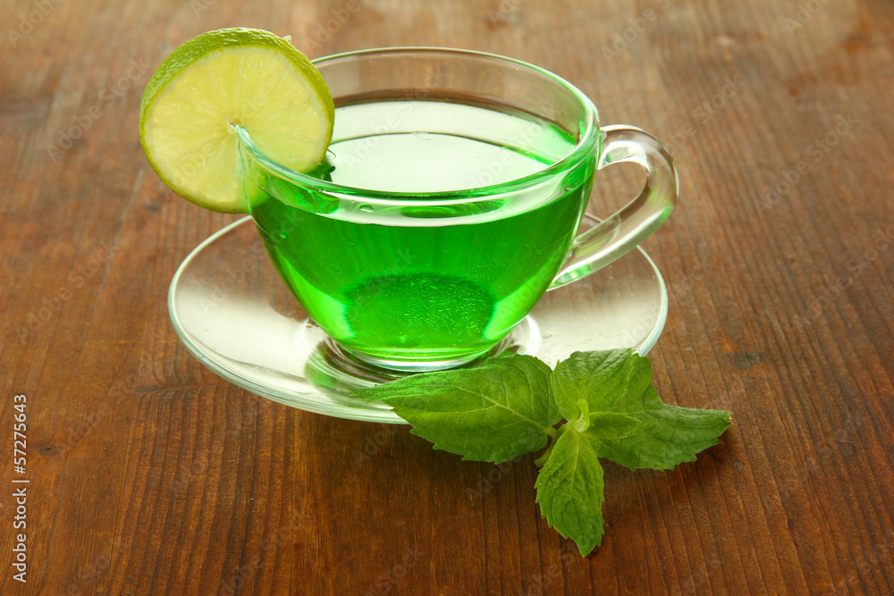 Transparent cup of green tea with lime and mint Transparent cup of green tea with lime and mint