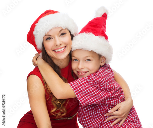 happy mother and child boy in santa helper hats
