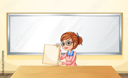 A teacher in front of the whiteboard holding an empty template