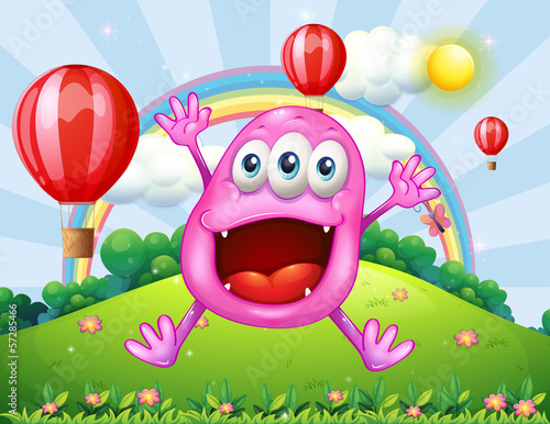 A hilltop with a very happy pink monster jumping