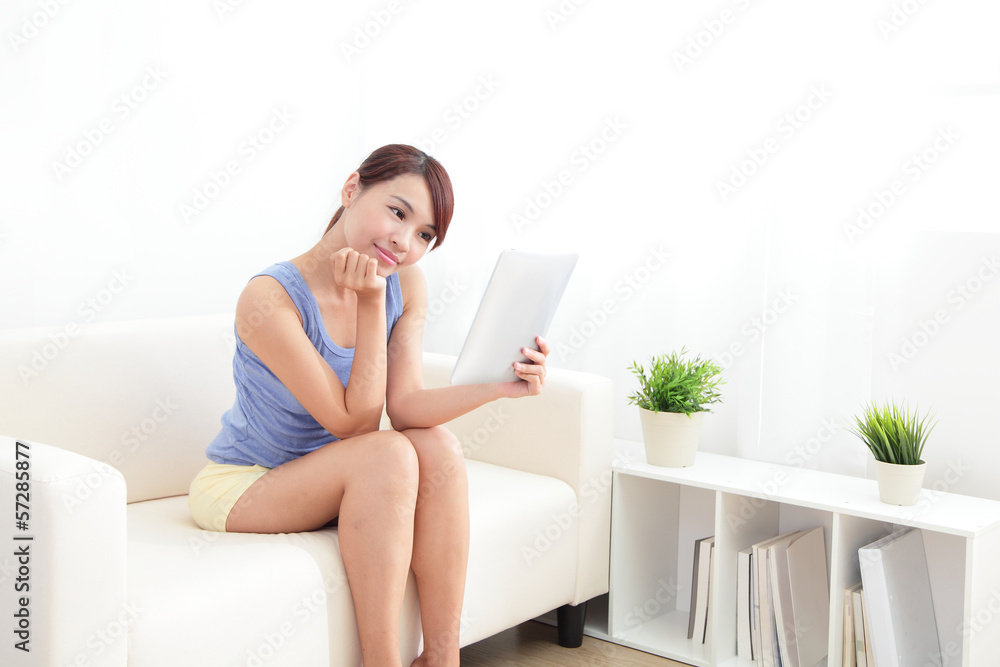 happy woman using tablet pc on sofa happy woman using tablet pc on sofa