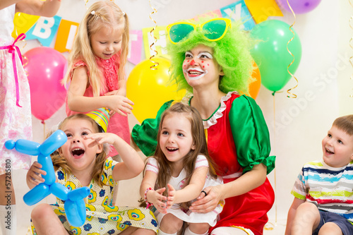 jolly children with clown on birthday party