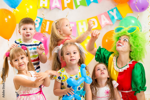 jolly kids group with clown celebrating birthday party