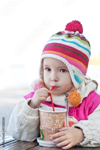 Cute little girl drinks