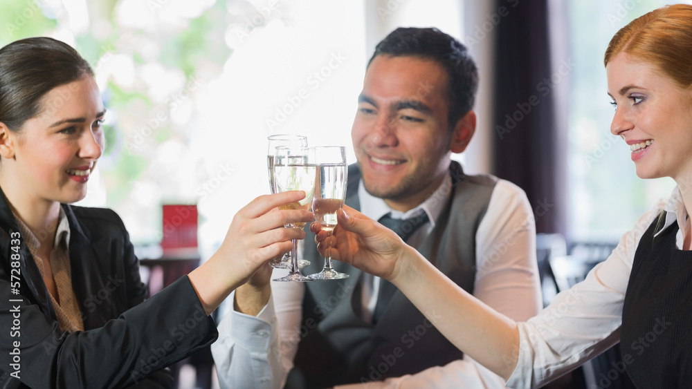 Smiling business people celebrating with champagne Smiling business people celebrating with champagne