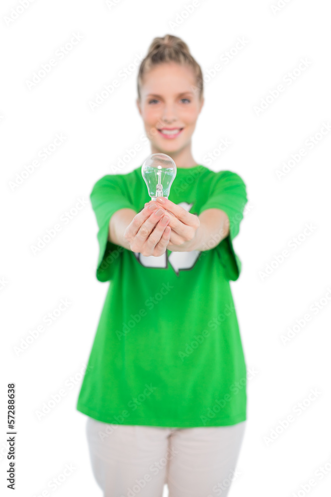 Cheerful activist wearing recycling tshirt holding light bulb Cheerful activist wearing recycling tshirt holding light bulb
