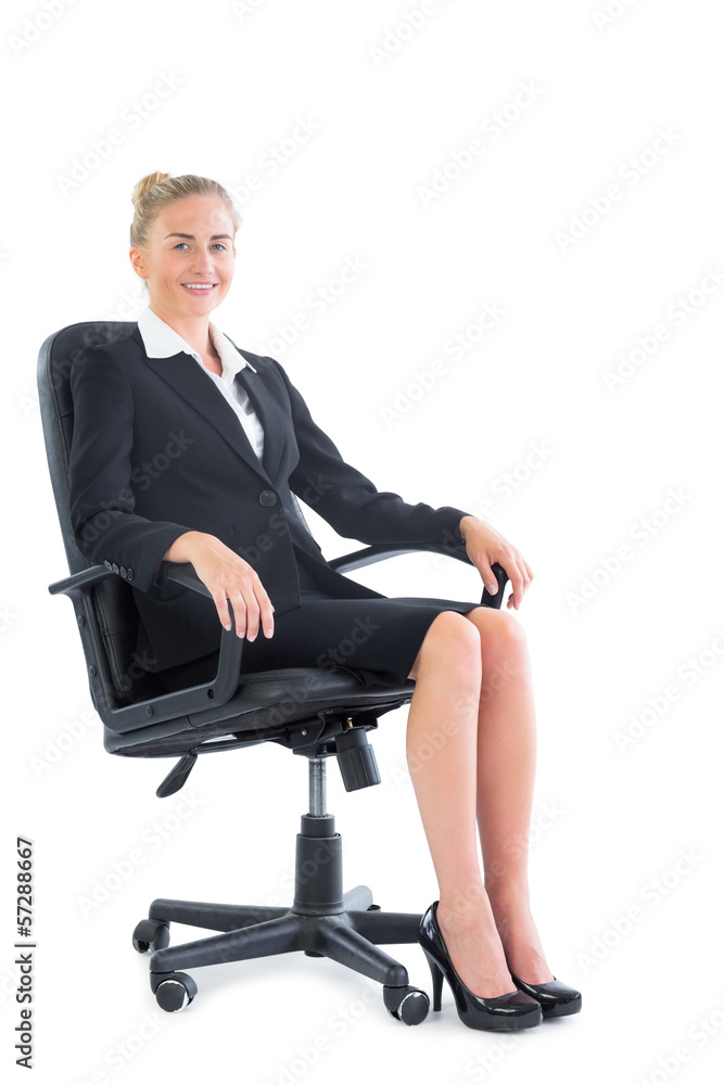 Side view of happy businesswoman sitting on an office chair Side view of happy businesswoman sitting on an office chair