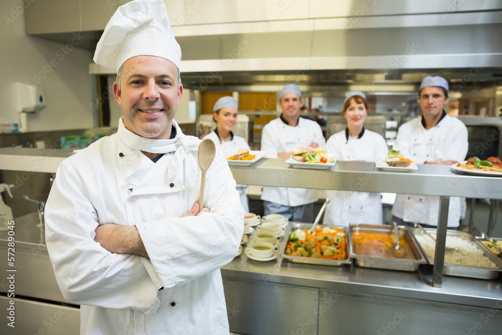 Experienced head chef posing proudly in a modern kitchen Experienced head chef posing proudly in a modern kitchen