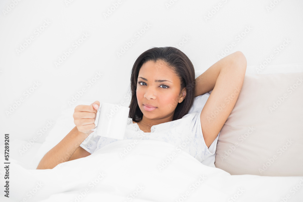Relaxed young dark haired model holding a mug Relaxed young dark haired model holding a mug
