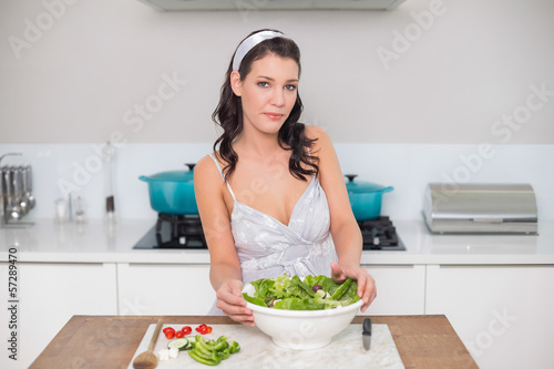 Content pretty brunette preparing healthy salad