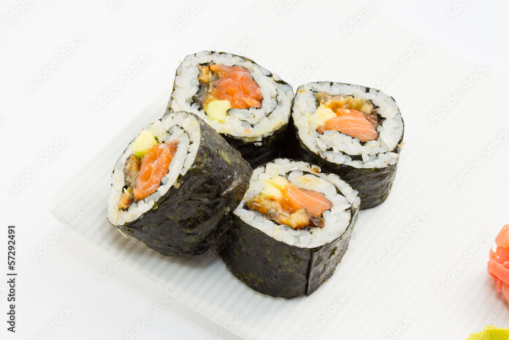 Sushi roll in nori on white plate with ginger and wasabi Sushi roll in nori on white plate with ginger and wasabi