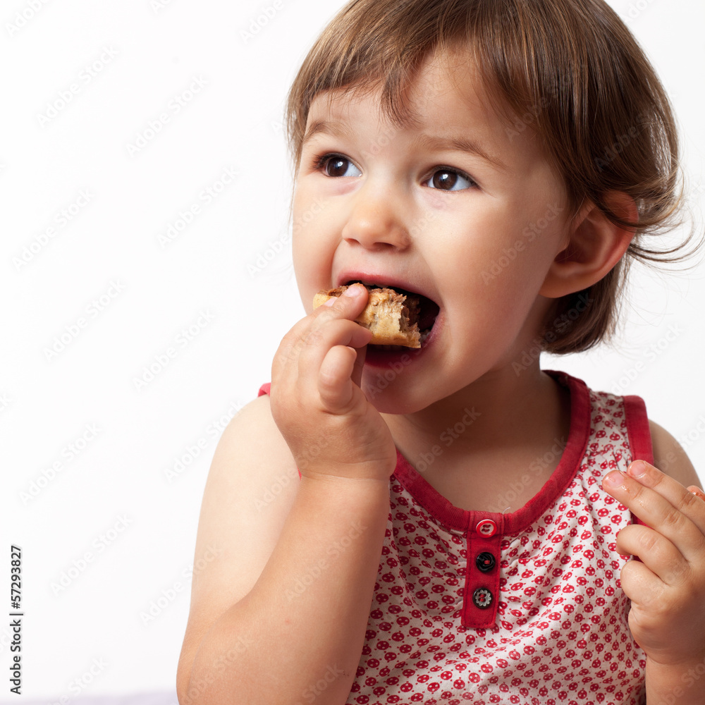 baby girl eating with pleasure and fun at two years old baby girl eating with pleasure and fun at two years old