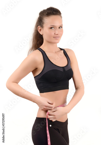 Fit girl measuring her waist with a measuring tape in inch © luanateutzi