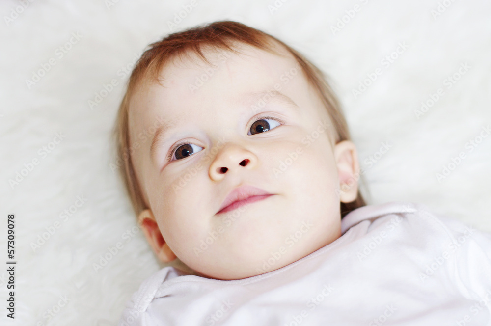 portrait of lovely baby lying on white bed portrait of lovely baby lying on white bed