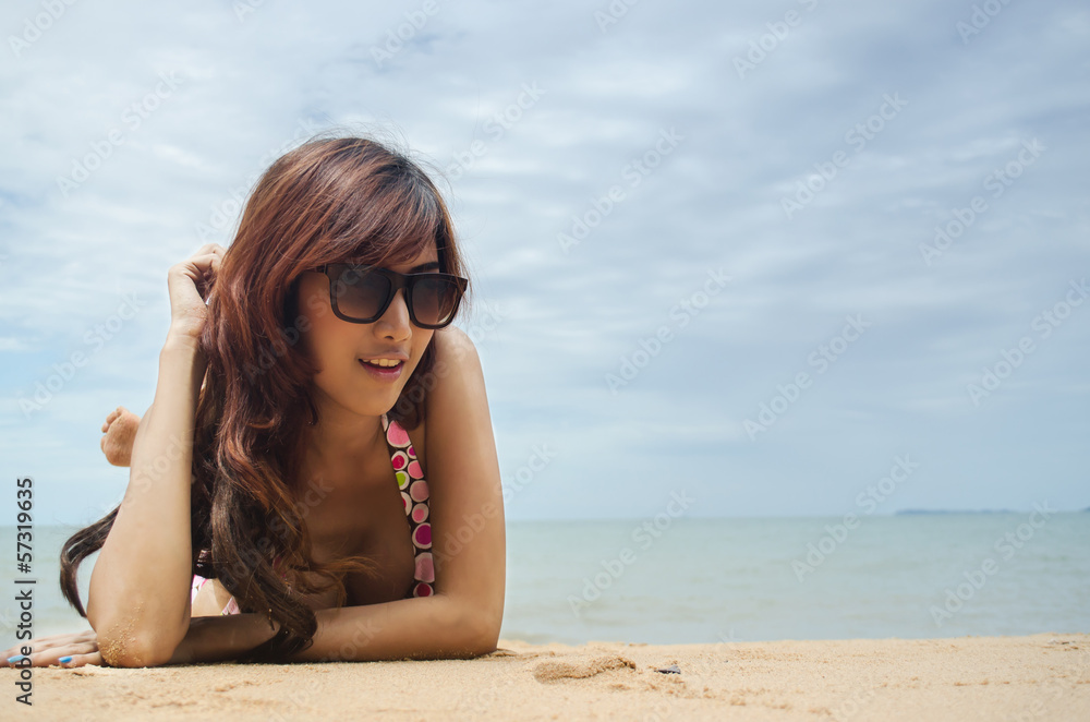 asian women laying on the beach wearing bikini asian women laying on the beach wearing bikini