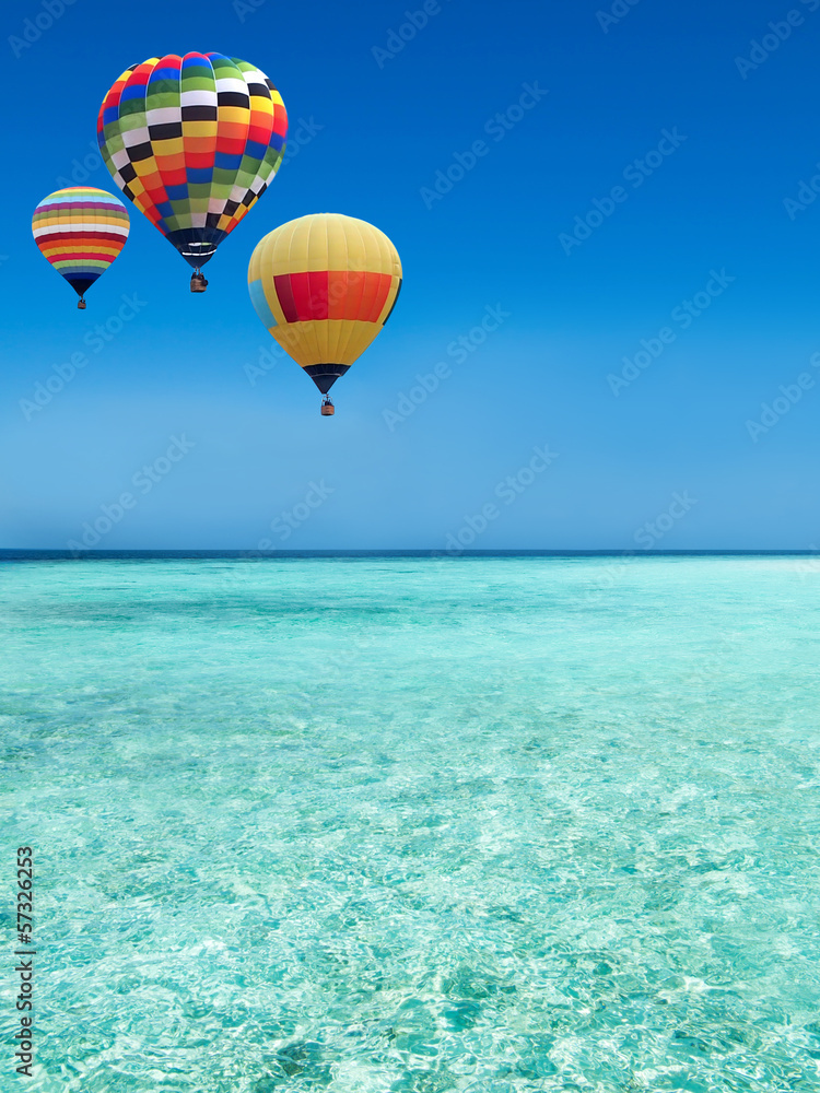 Fototapeta premium Hot air balloons travel over the sea